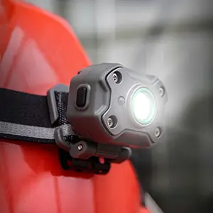 Lighthouse Mini LED Headlight worn over safety helmet